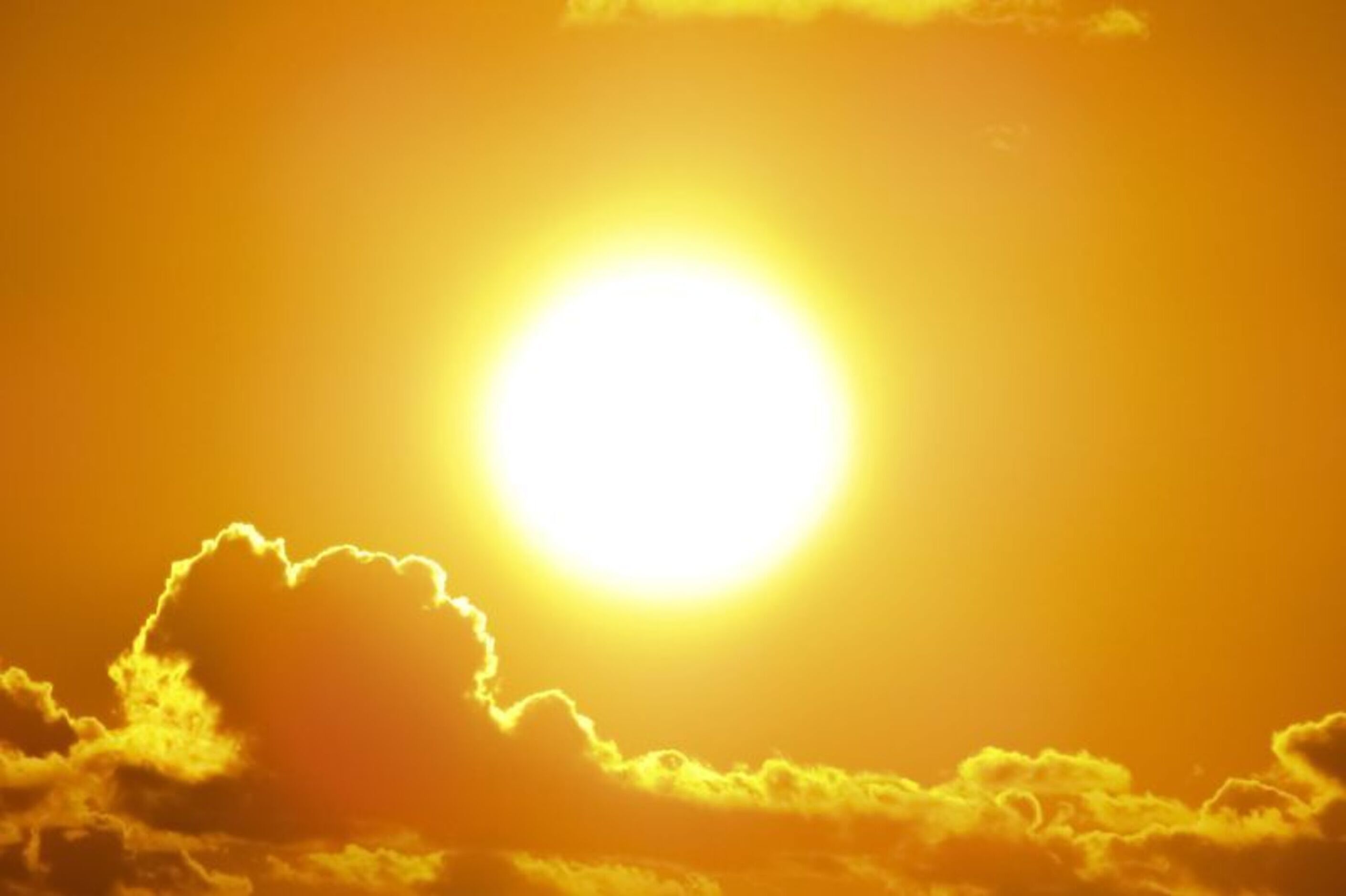 Bright sun in the middle of a yellow, orange sky
